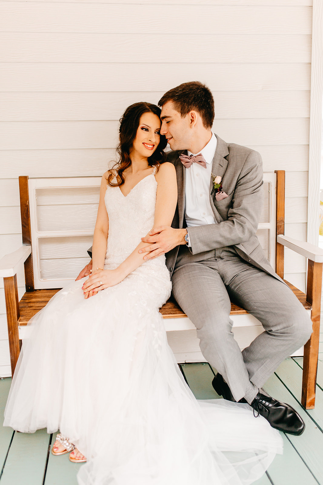 bride and groom on farmhouse bench