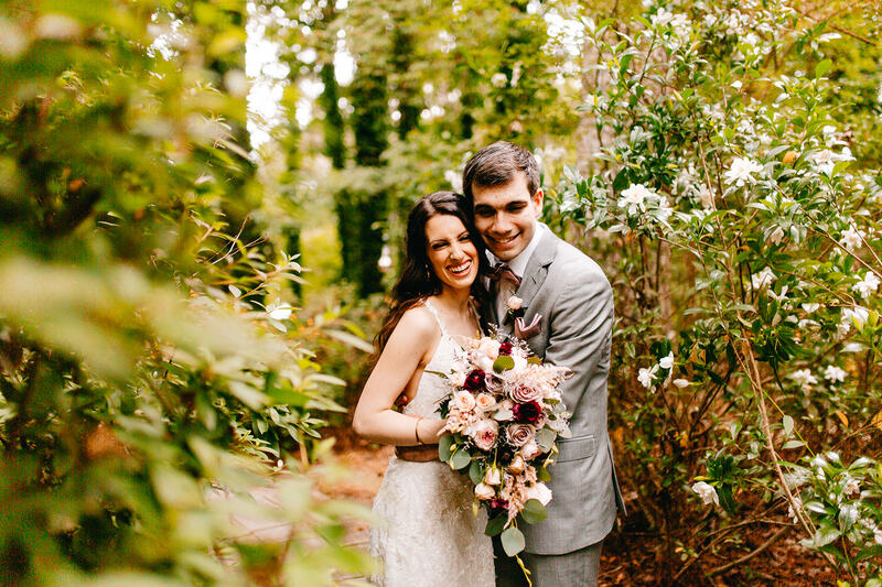 bride and groom laughing in gardens