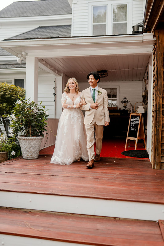 bride and groom introduced into reception from farmhouse porch