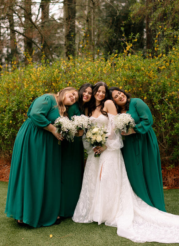 emerald green bridesmaids with baby's breath
