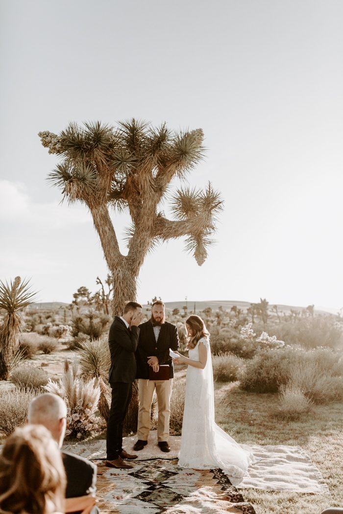 couple shares vow by officiant at outdoor micro-wedding in desert