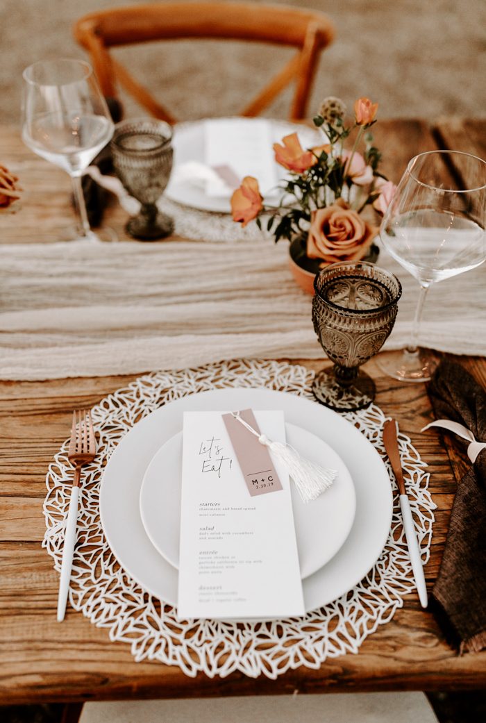 intimate wedding tablescape with printed menu on plate