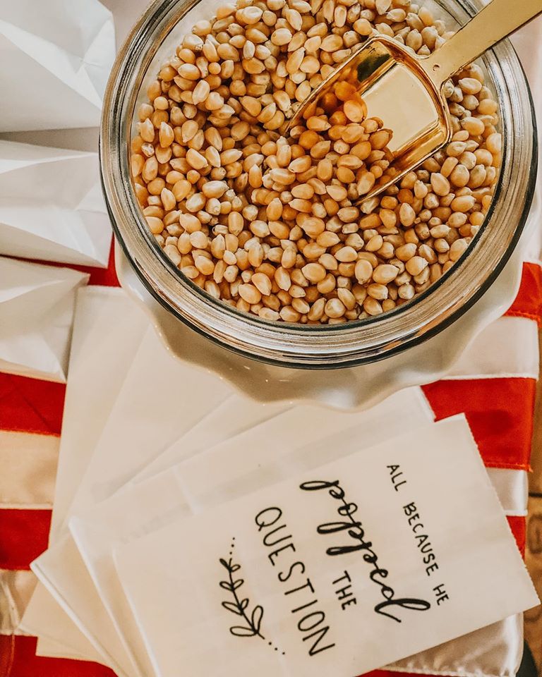 popcorn kernels with 'all because he popped the question' bags