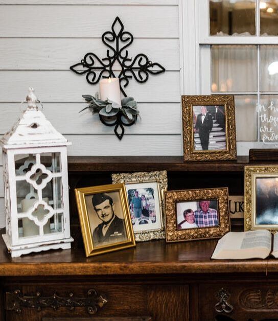 memorial photos and Bible on porch table