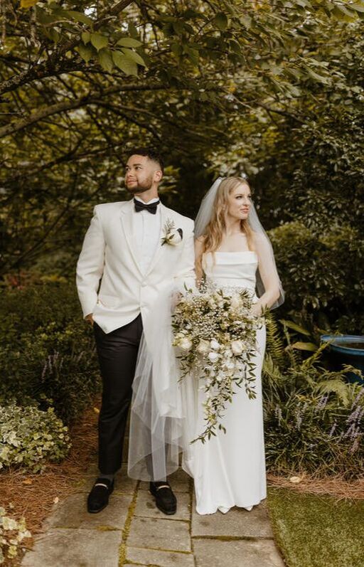 newlyweds posing along garden path