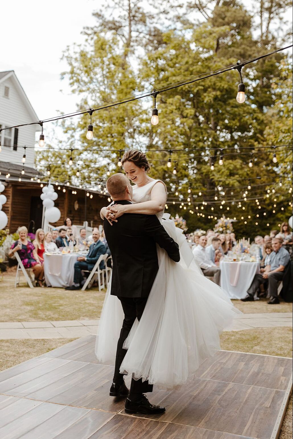 bride and groom doing waltz on outdoor dance floor