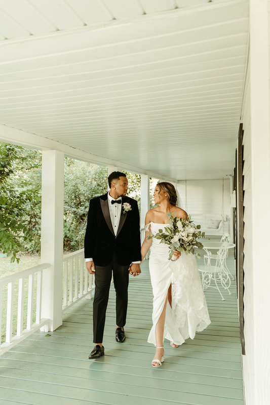 bride and groom walking down farmhouse front porch