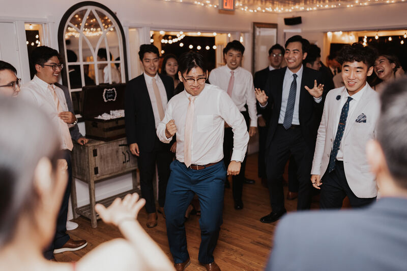 groomsmen dancing on indoor dance floor