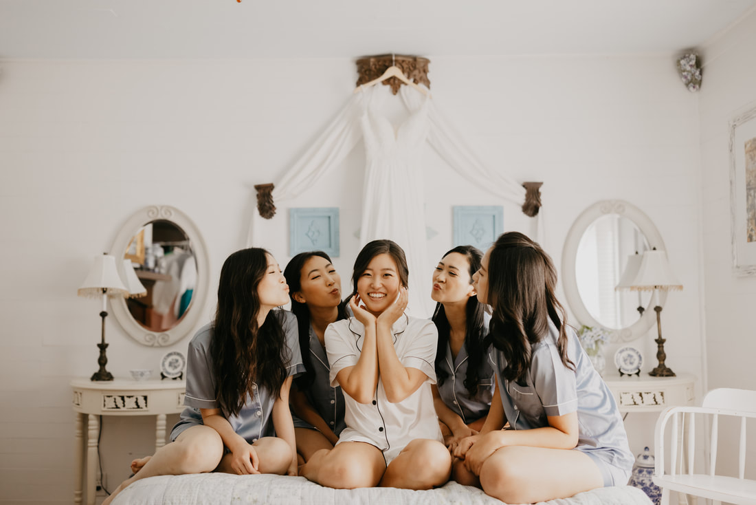 bride with bridesmaids on bed