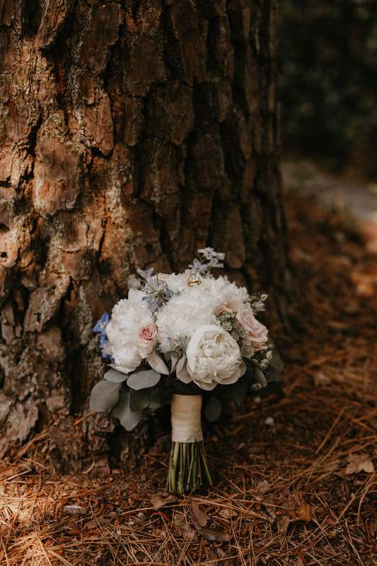 bride's bouquet leaning against tree