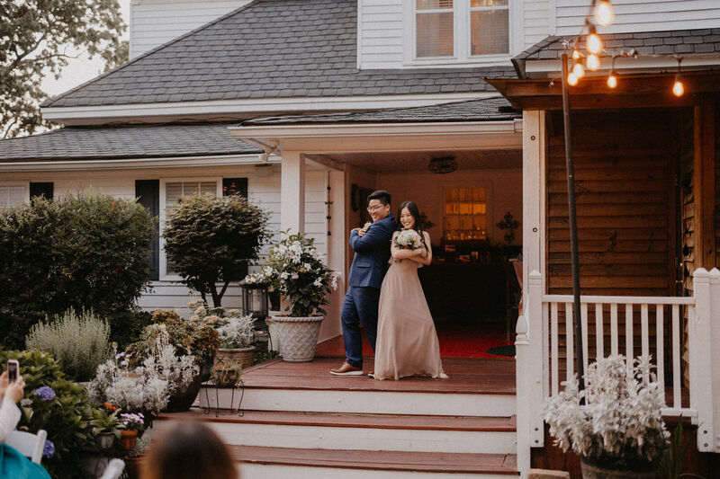 wedding party posing on porch during introductions