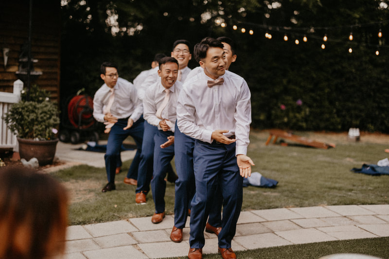 groom and groomsmen surprise dancing for bride