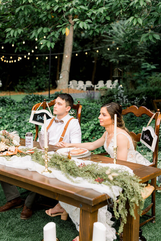 bride and groom at head table in garden venue