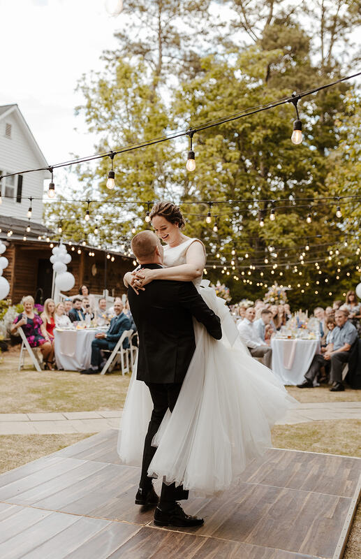 bride and groom's first dance on outdoor dance floor