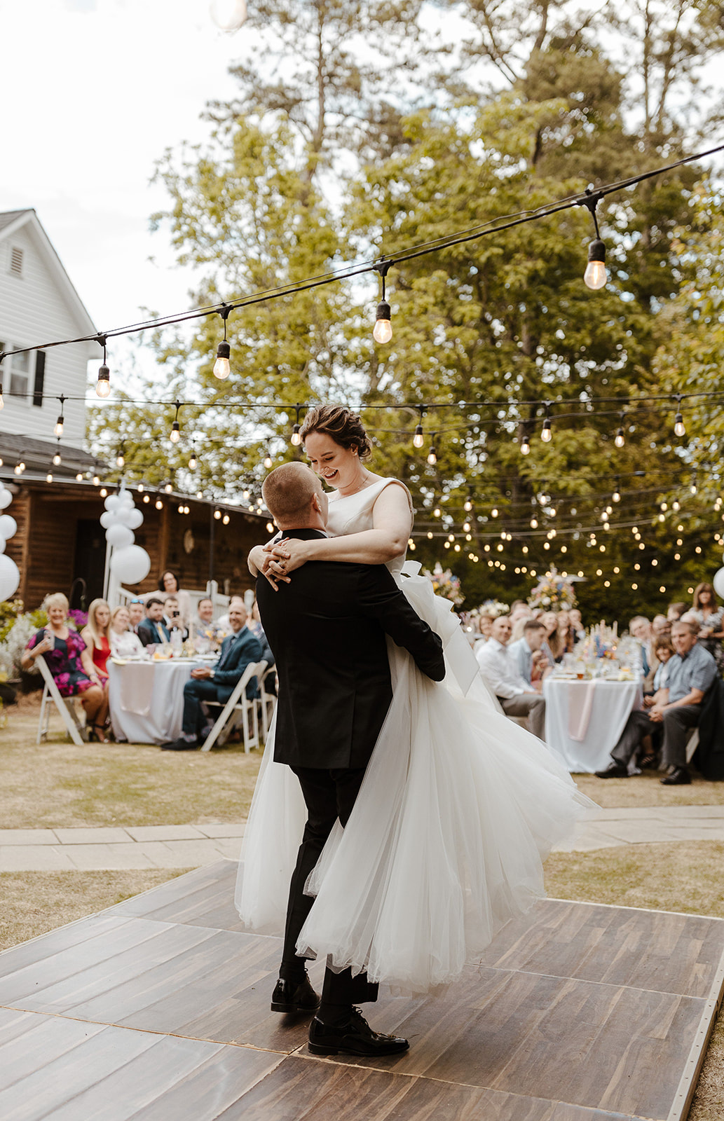 couple performs waltz on outdoor dance floor