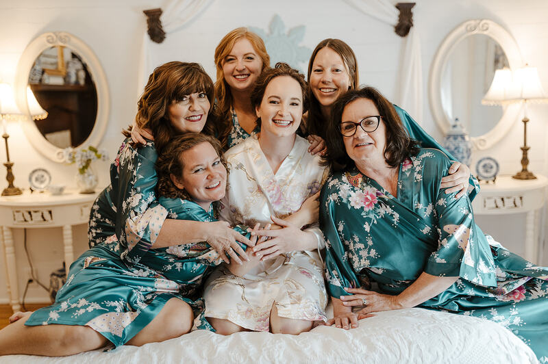 bride and bridesmaids in teal floral silk robes