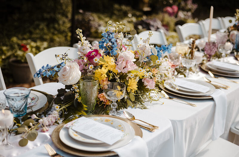banquet-style reception with tables decorated with bright florals