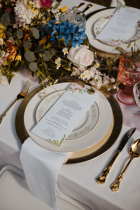 champagne place settings with floral arrangements and details