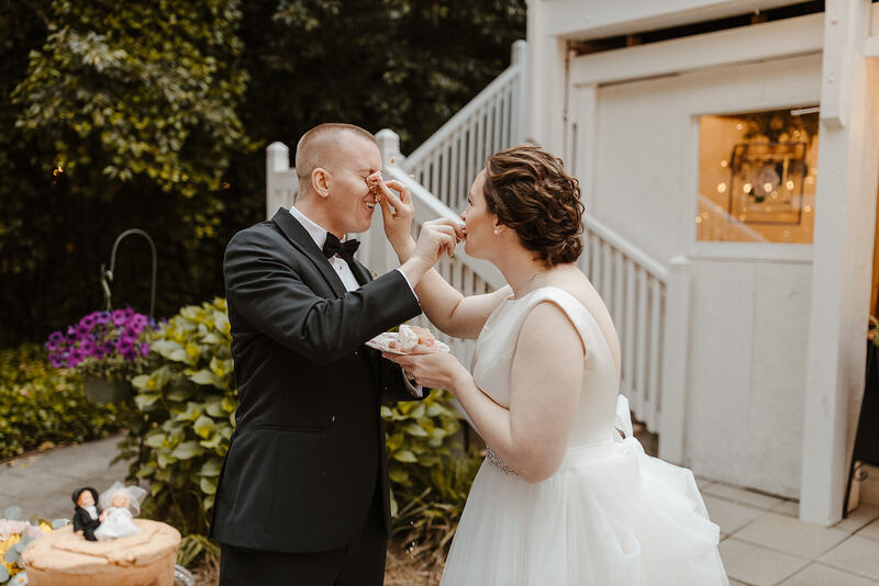 bride shoving cake in groom's face during cake cutting