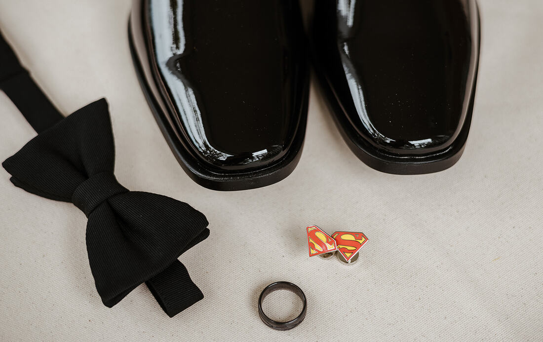 black groom's details with Superman cufflinks