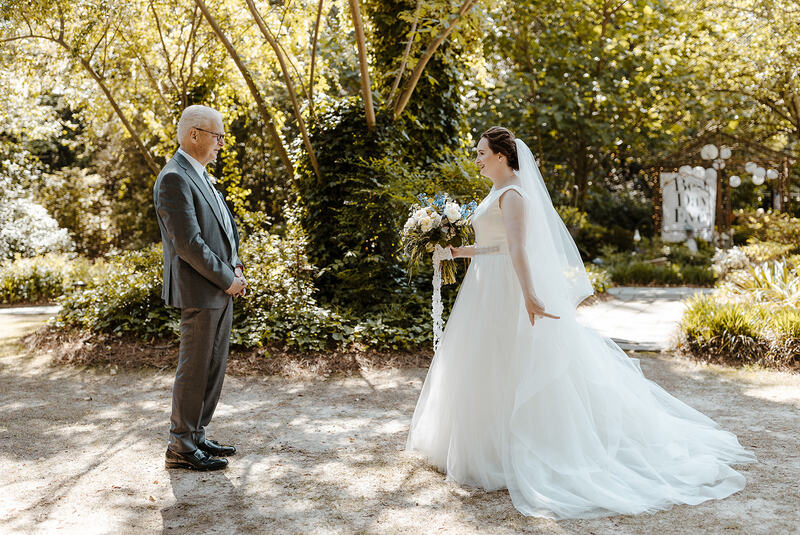 bride's first look with dad in spring gardens