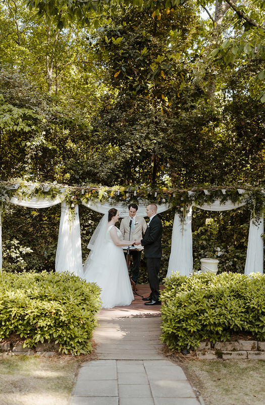 outdoor spring ceremony with greenery-covered altar