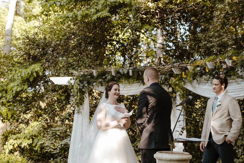 bride reading vows during outdoor ceremony