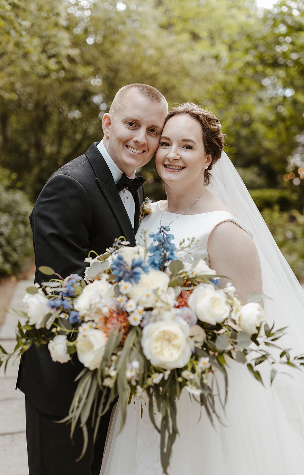 bride and groom with large bridal bouquet