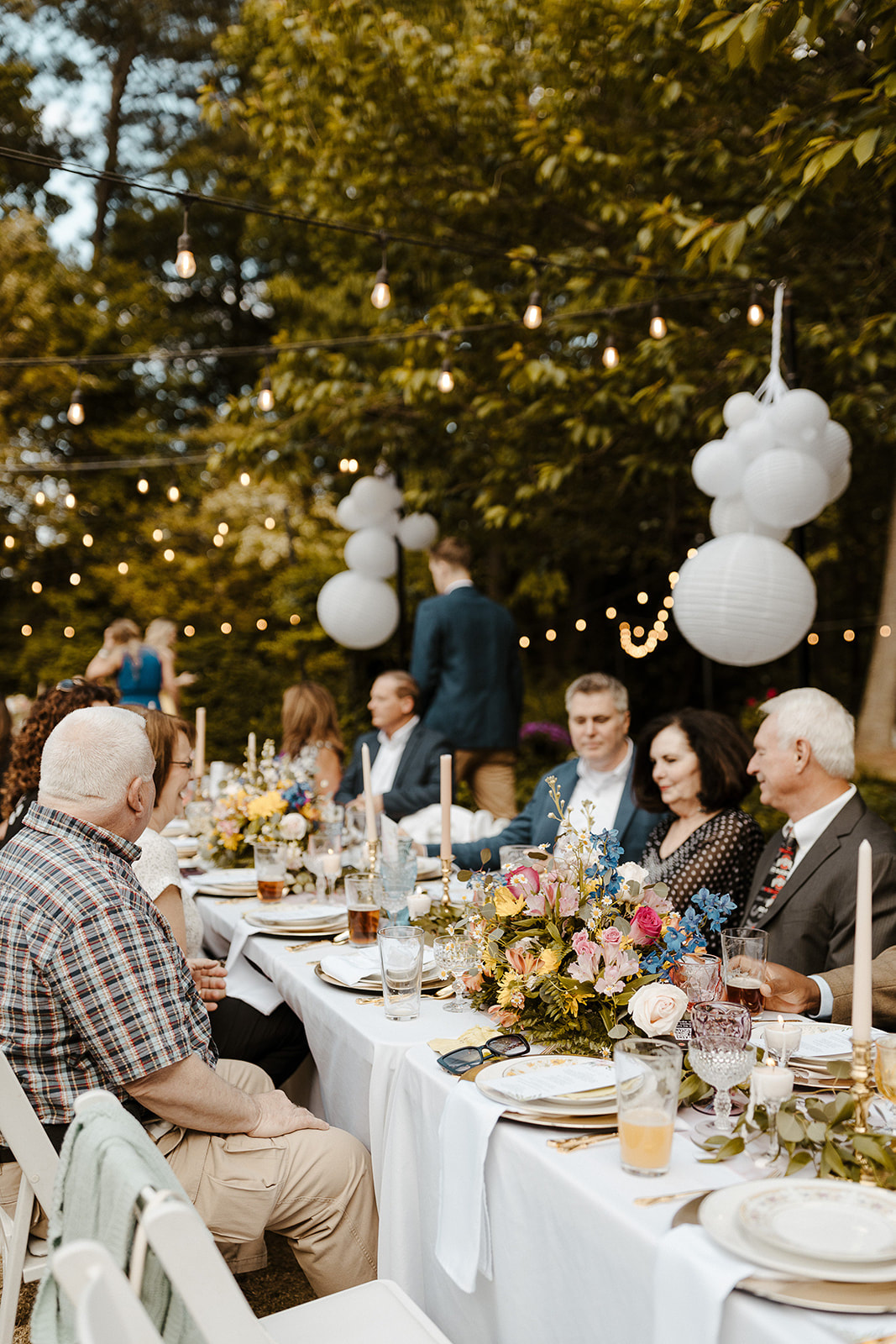 guests sitting at outdoor reception tables during cocktail hour