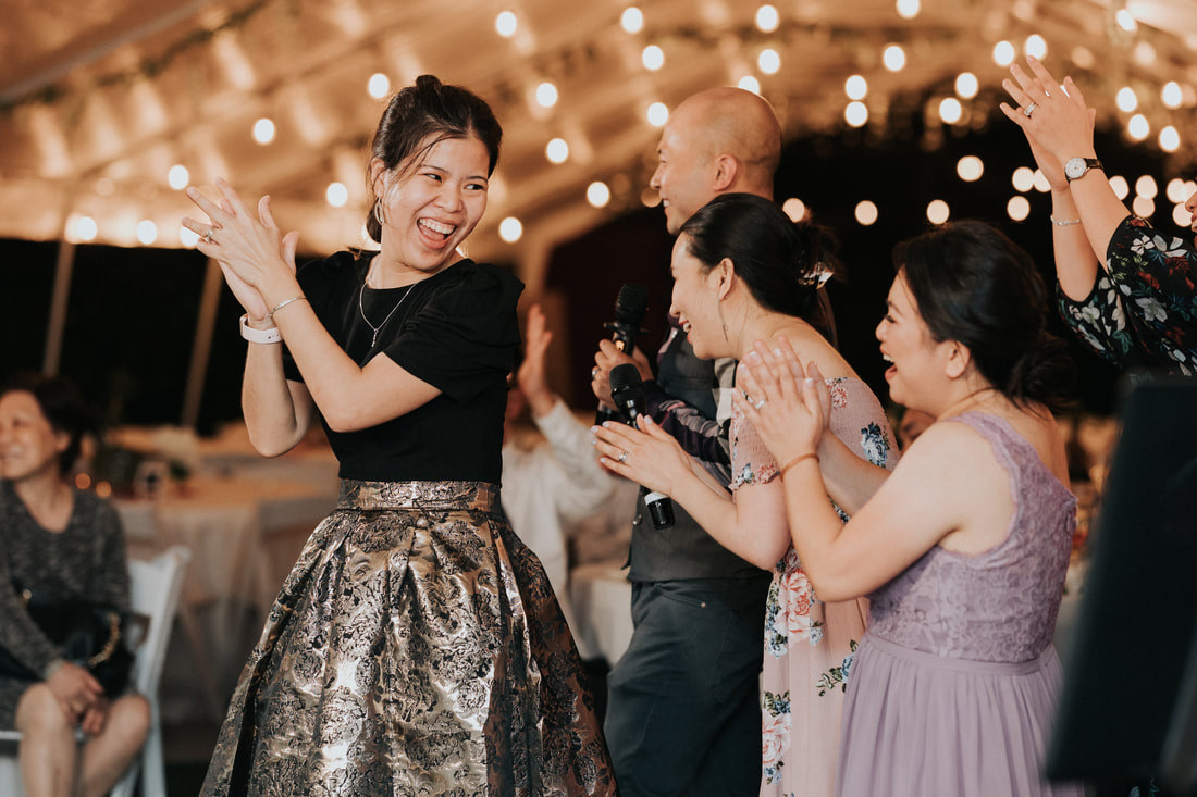 Guests clap and dance together at a wedding.