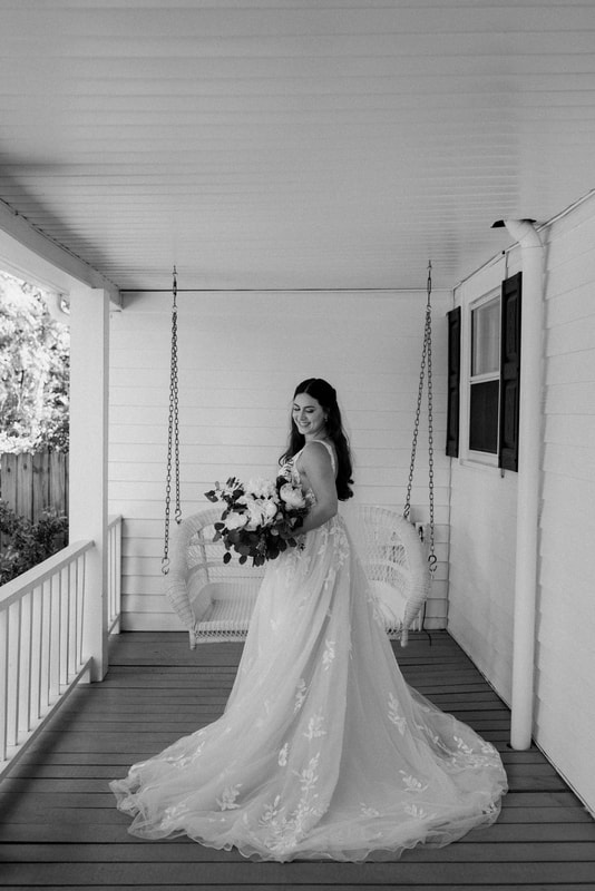 black and white photo of bride on front porch