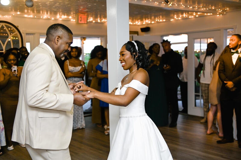 bride sharing dance with father in carriage house dance room