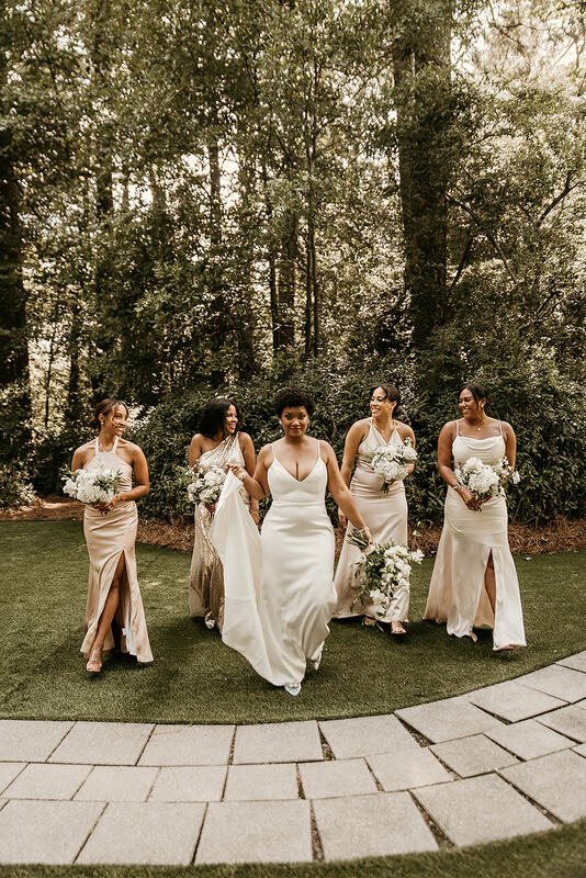bride walking with bridesmaids in champagne dresses