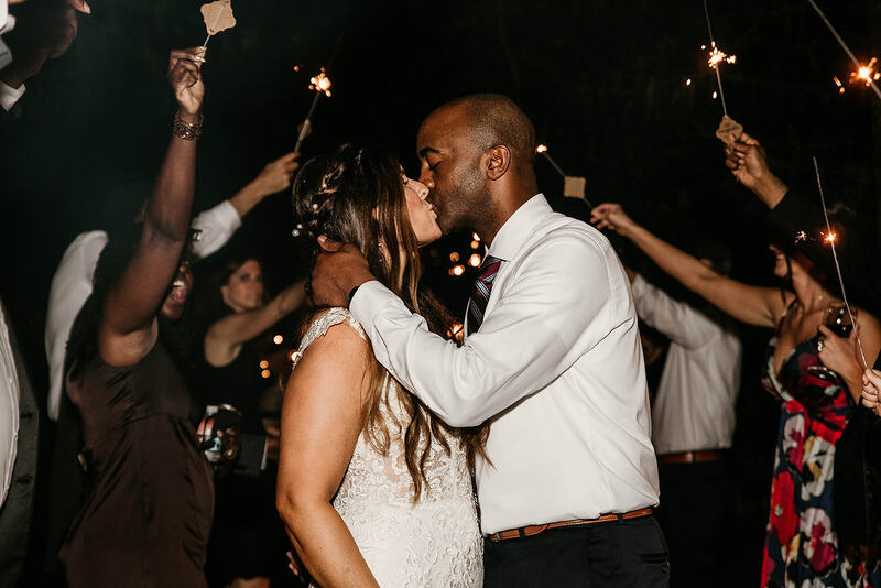 couple kissing during sparkler grand exit