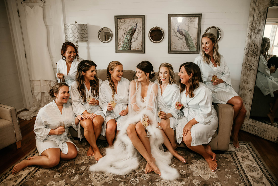 bridesmaids and bride drinking champagne in bridal suite