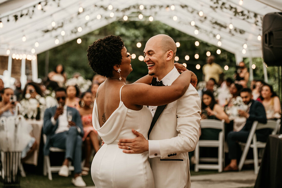 bride and groom's first dance at tented reception