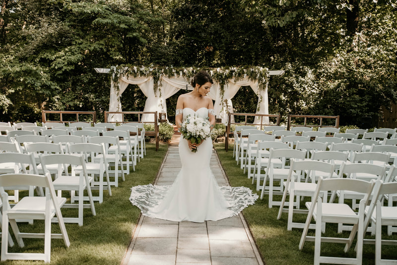 bride at outdoor altar with ceremony benches