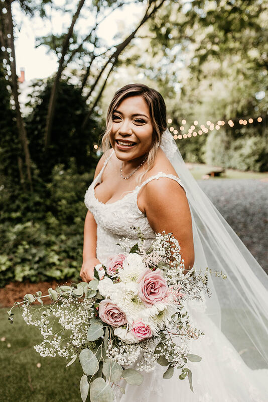 bride in lace dress posing in garden venue