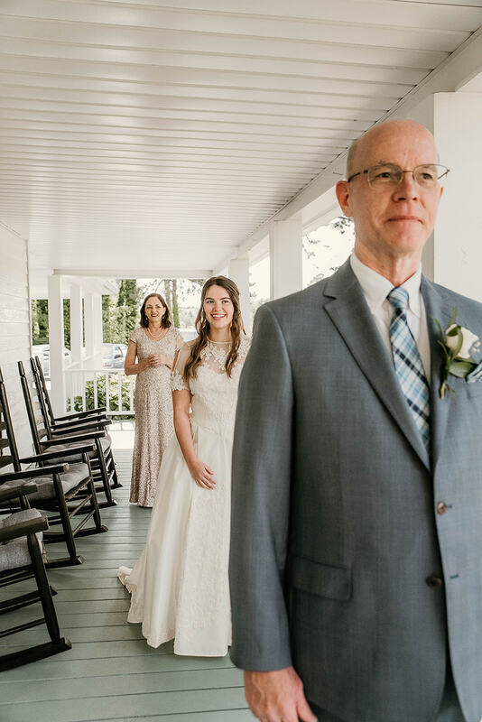 bride and parents on porch during 1st look with father