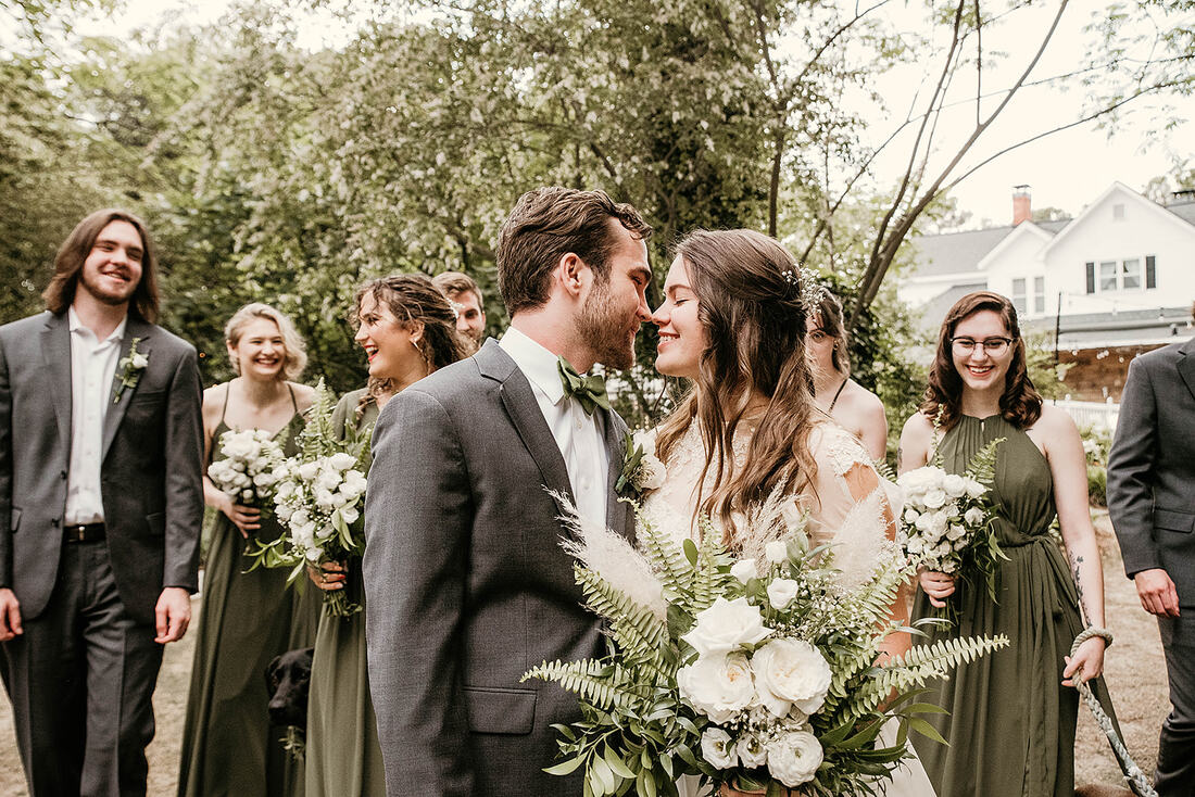 bride and groom with olive and gray bridal party