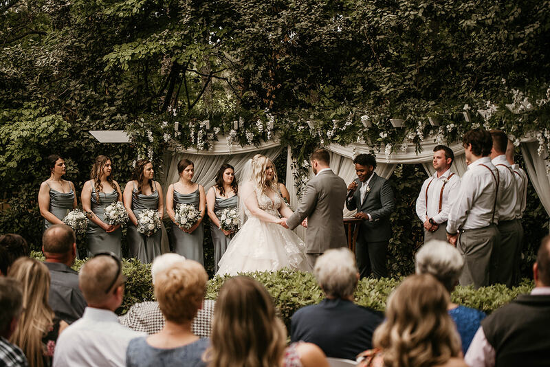 spring garden ceremony with gray and french blue wedding party