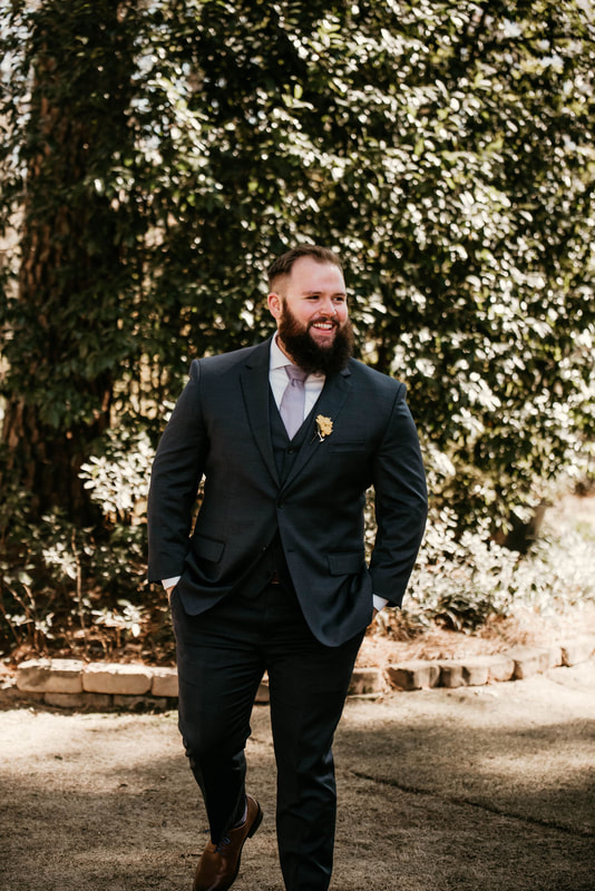 groom in charcoal suit with lavender tie