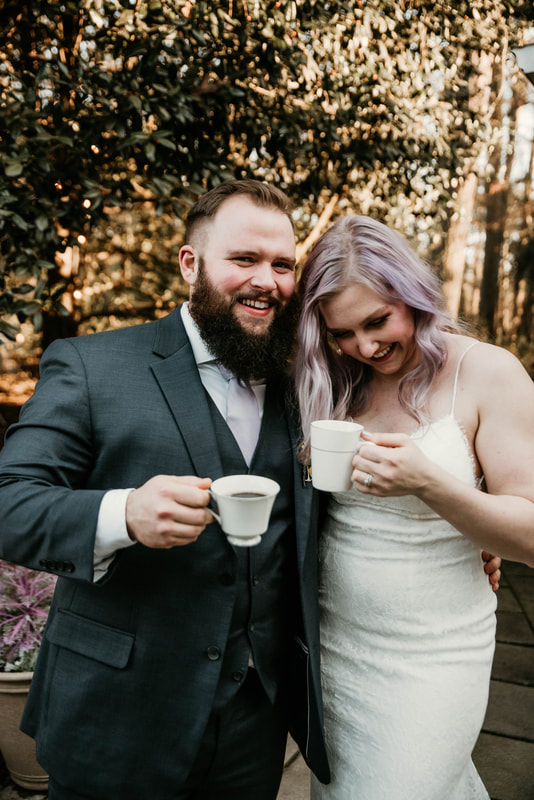 couple laughing and holding vintage china coffee mugs