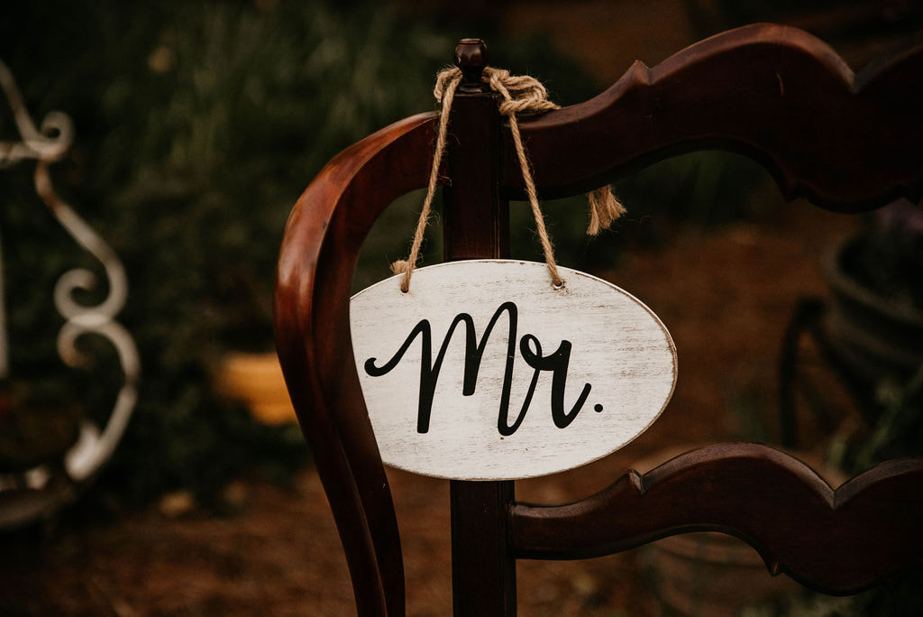 wood chair with Mr. sign at head table