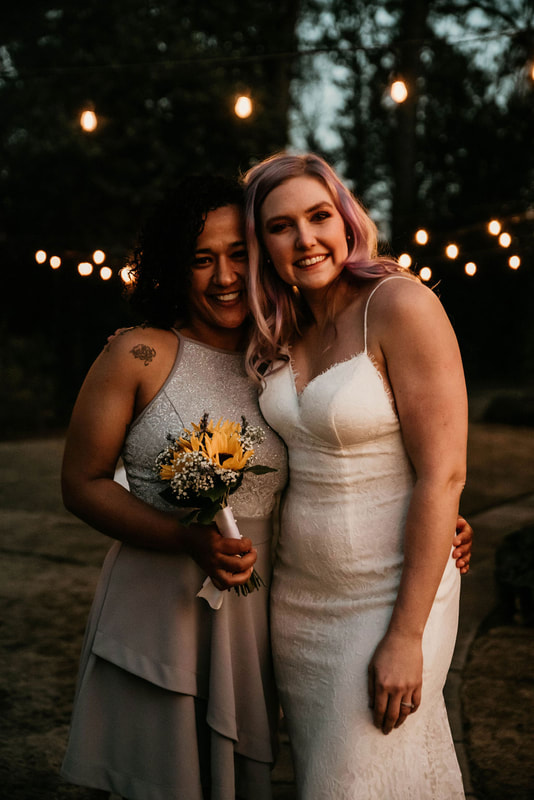 bride with friend who caught sunflower bouquet