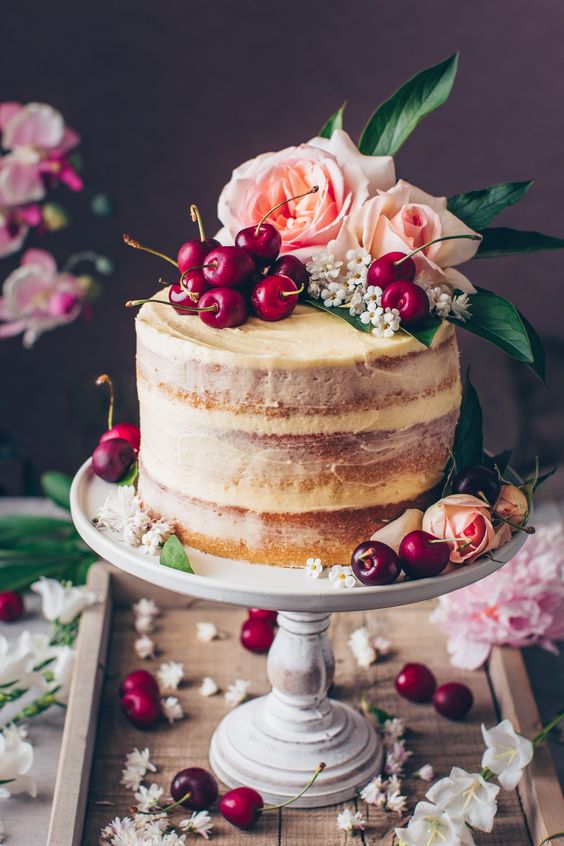 vegan wedding cake with cherries and flowers