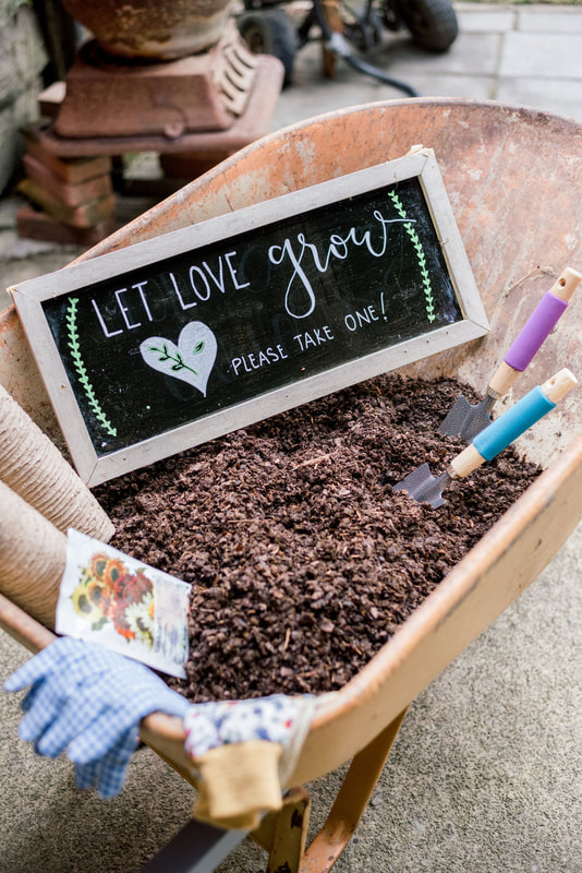 seeds wedding favors in wheel barrow filled with dirt and 