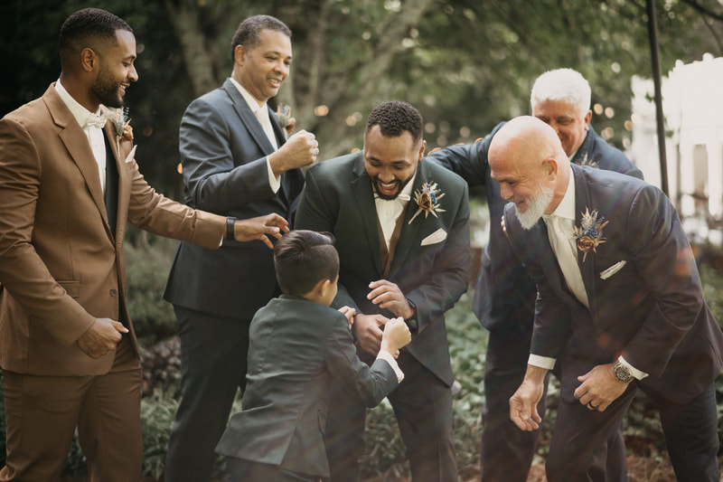 groom laughing with groomsmen 